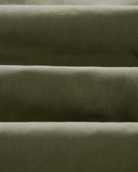 material shot of the twill fabric on The Slim Foundation Pant in Organic Smoked Olive, Bottoms by Taylor Stitch