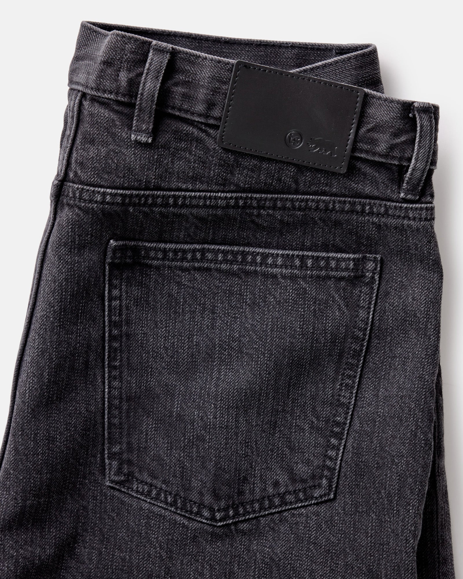 material shot of the back pocket on The Slim Jean in Washed Black Organic Slub Selvedge, Bottoms by Taylor Stitch