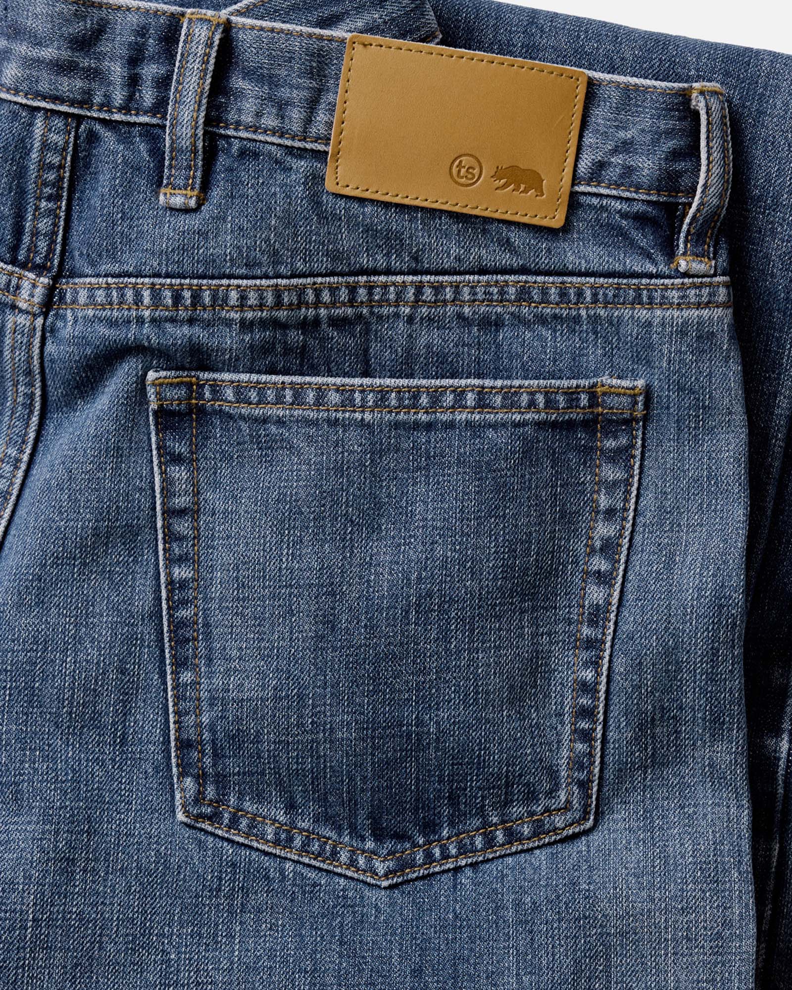 material shot of the back pocket on The Straight Jean in Mid Wash Organic Selvedge, Bottoms by Taylor Stitch