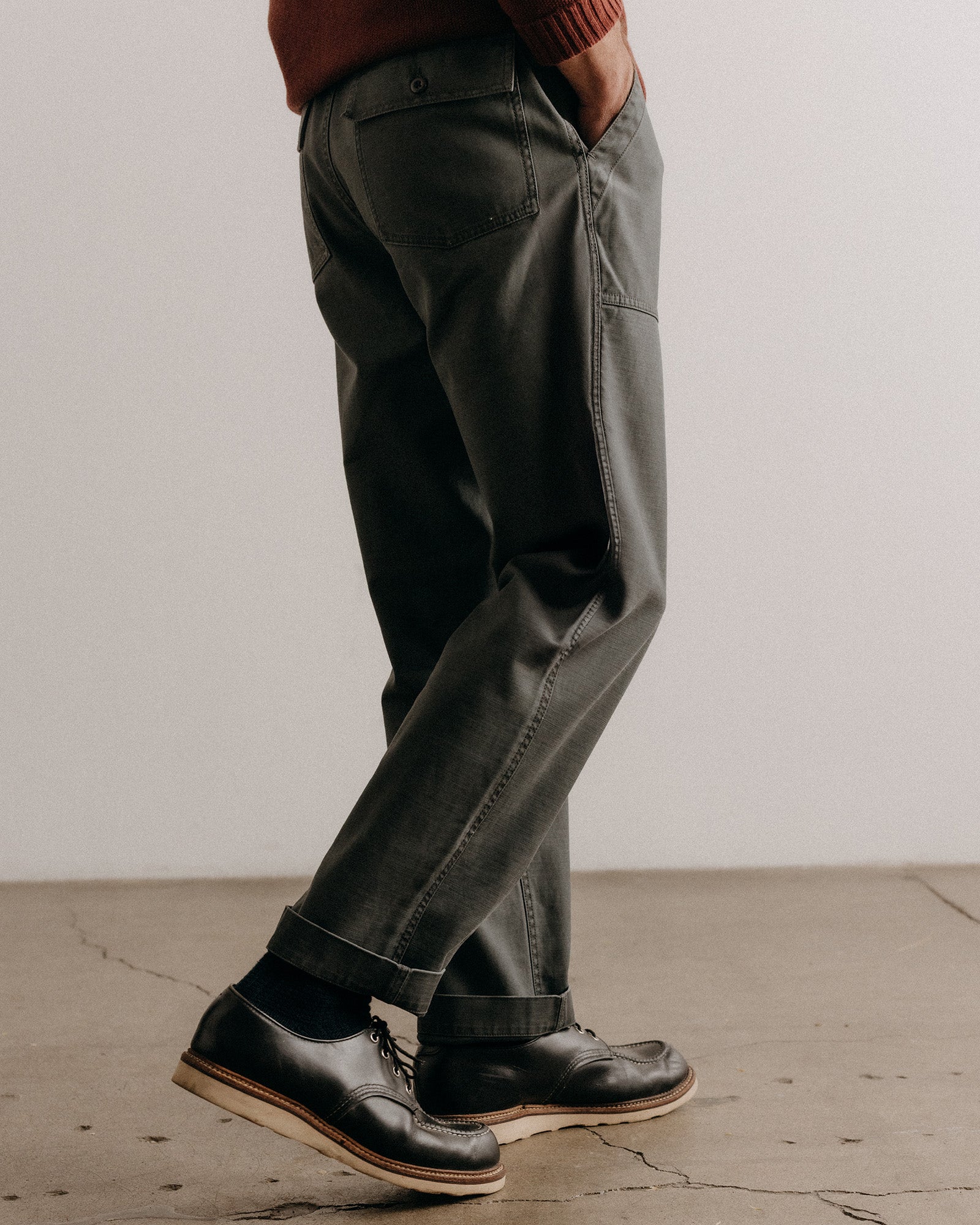 fit model walking wearing The Surplus Pant in Faded Black Reverse Sateen, Bottoms by Taylor Stitch