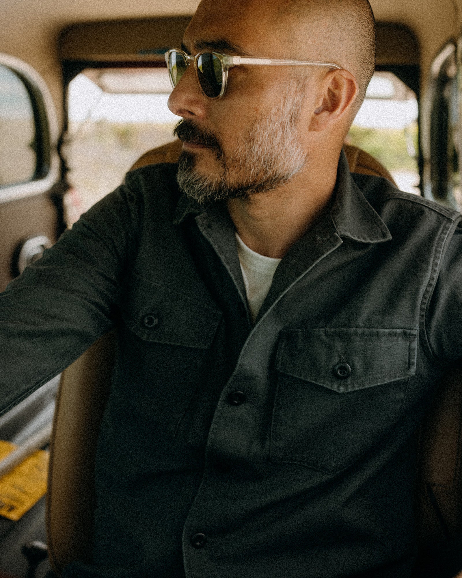 fit model posing in The Surplus Shirt in Faded Black Reverse Sateen, Wovens by Taylor Stitch