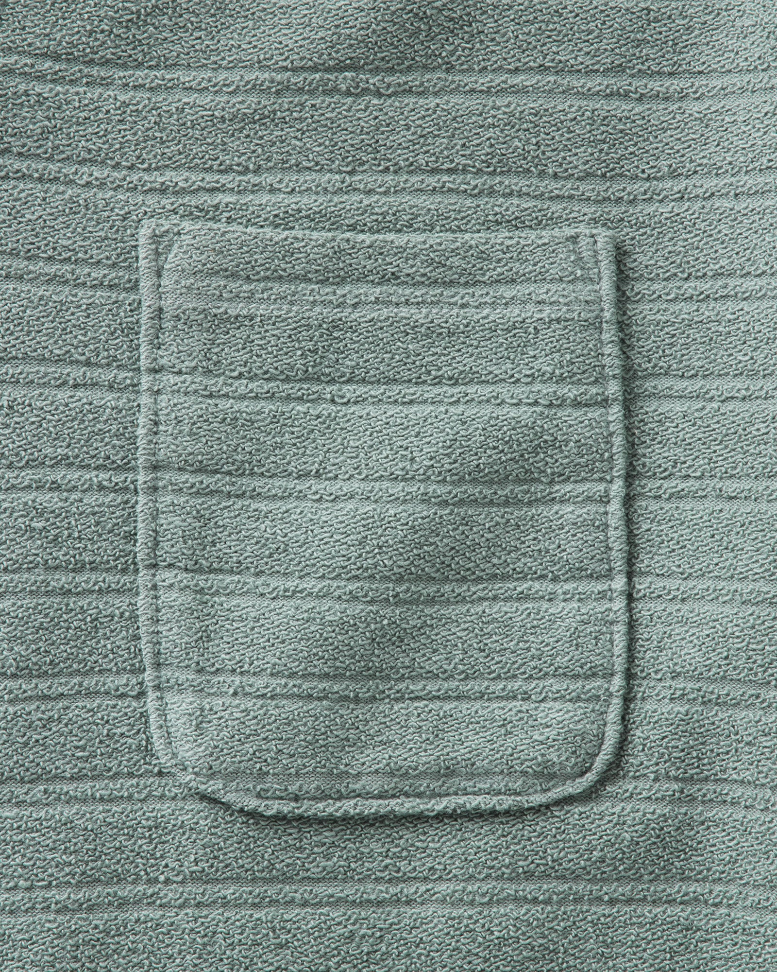 material shot of the pocket on The Meridian Polo in Faded Pine, Knits by Taylor Stitch