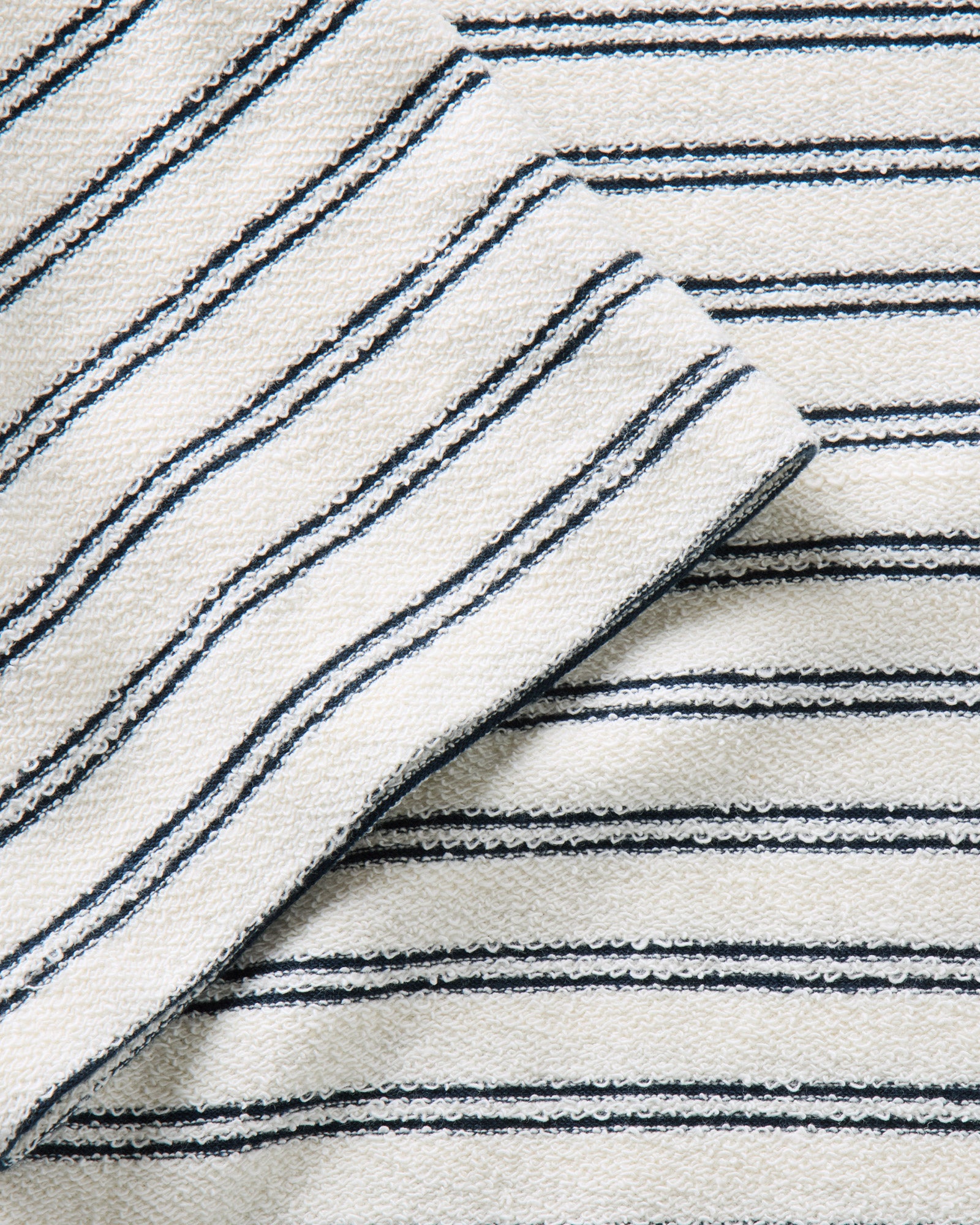 material shot of the sleeve on The Meridian Polo in Marine Stripe, Knits by Taylor Stitch