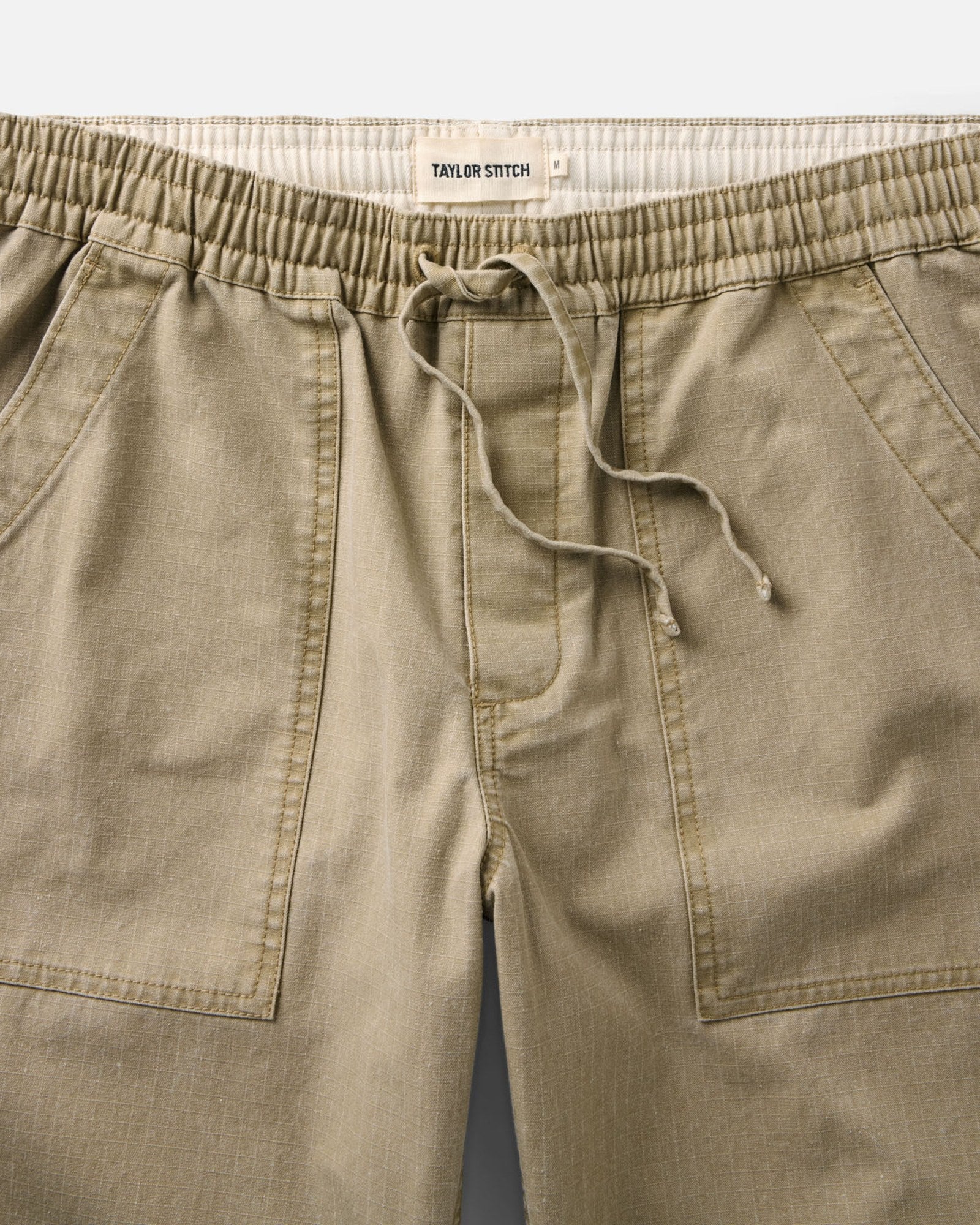 material shot of the waistband on The Breakwater Pant in Field Khaki Ripstop, Bottoms by Taylor Stitch