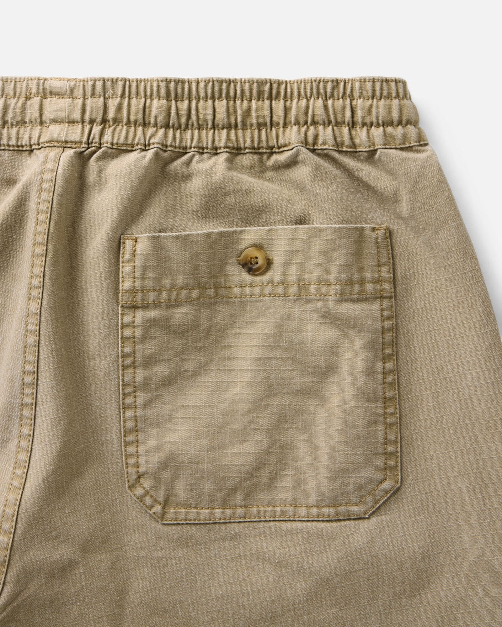 material shot of the back pocket on The Breakwater Pant in Field Khaki Ripstop, Bottoms by Taylor Stitch