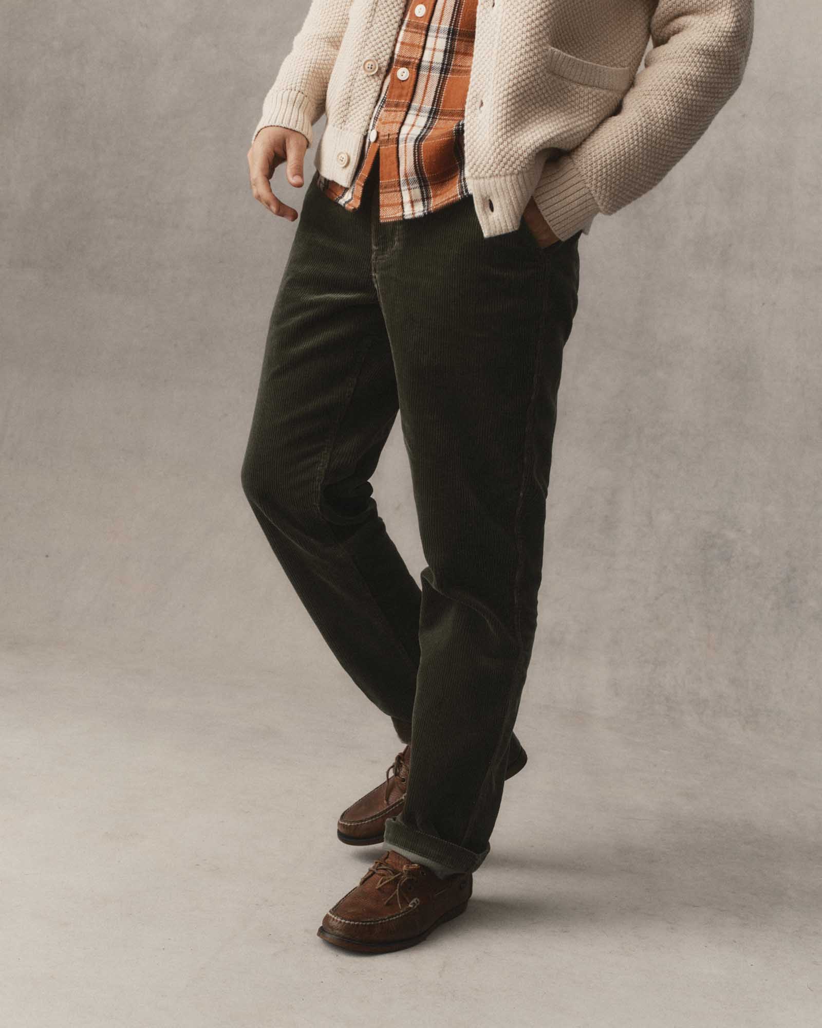 fit model posing in The Carnegie Pant in Smoked Olive Corduroy, Bottoms by Taylor Stitch