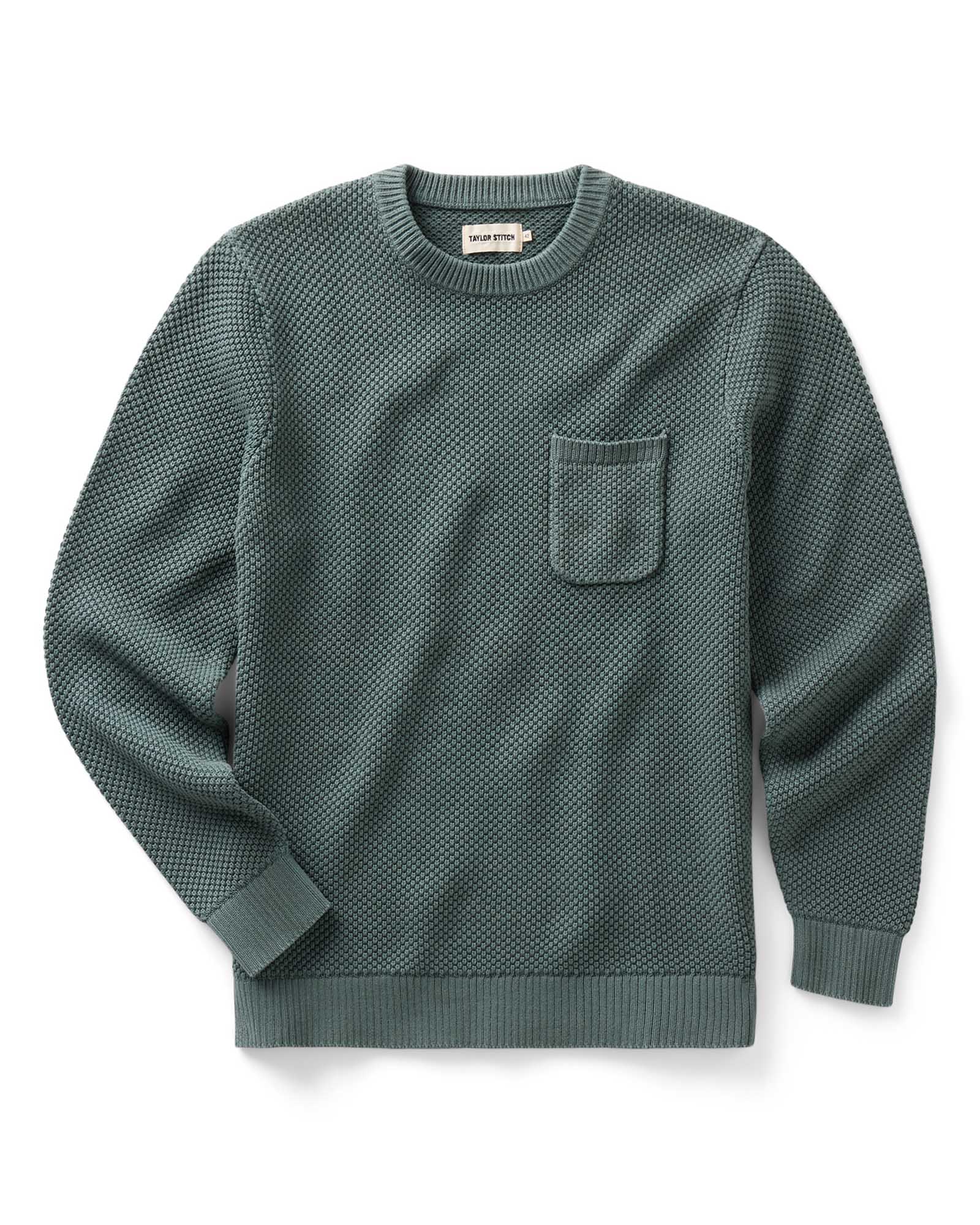 flatlay of The Crawford Crew Sweater in Faded Spruce, Knits by Taylor Stitch