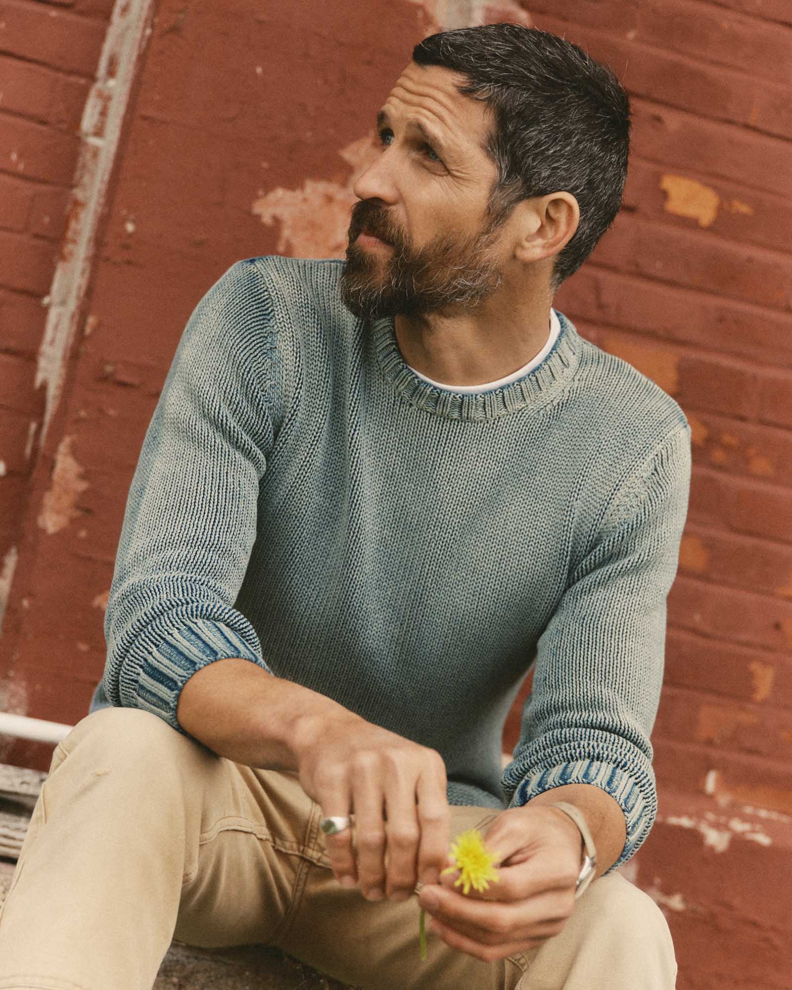 fit model sitting wearing The Dory Crew Sweater in Washed Indigo, Knits by Taylor Stitch