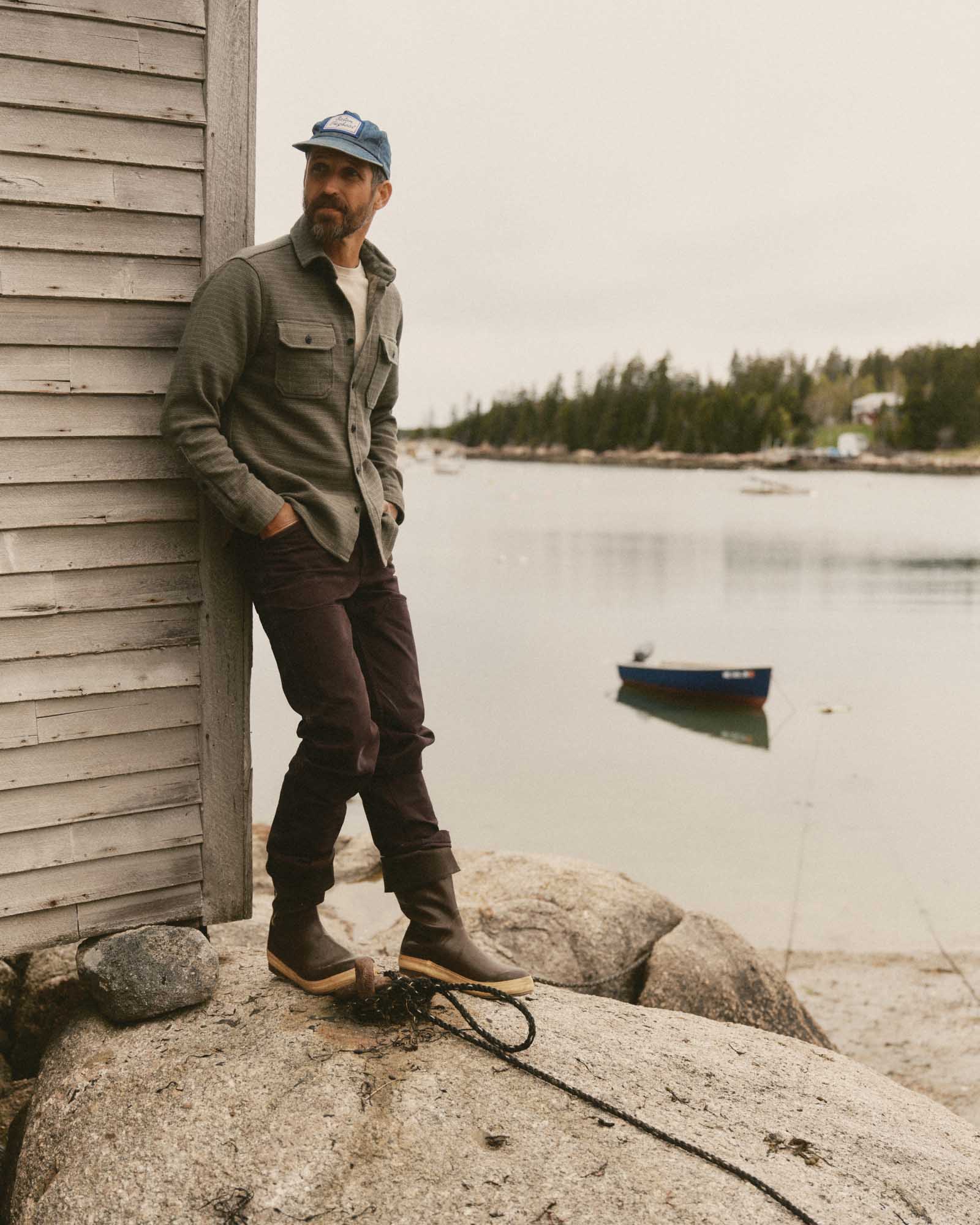 fit model leaning against the wall wearing The Good Acre Chore Pant in Coffee Canvas, Bottoms by Taylor Stitch