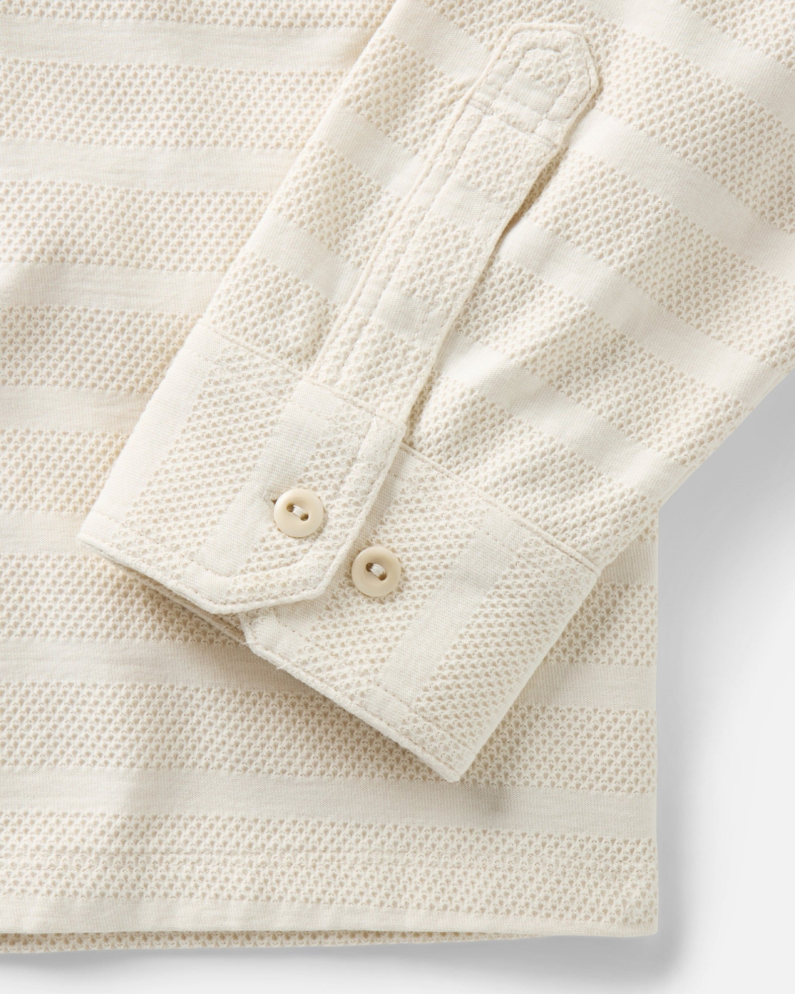 material shot of the sleeve on The Long Sleeve Polo in Vintage White Knit Stripe, Knits by Taylor Stitch