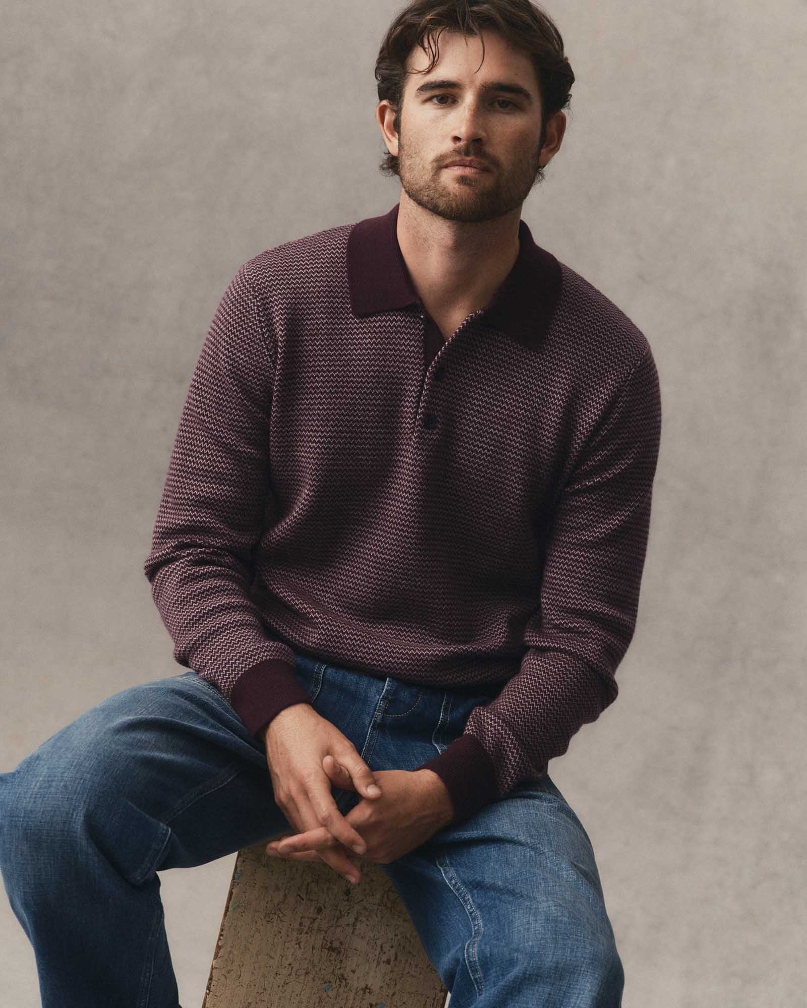 fit model sitting wearing The Newton Sweater Polo in Burgundy Birdseye Merino, Knits by Taylor Stitch