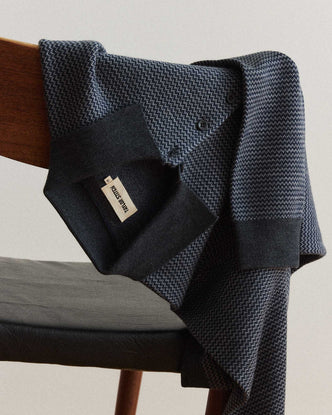 editorial image of The Newton Sweater Polo in Navy Birdseye Merino on a chair