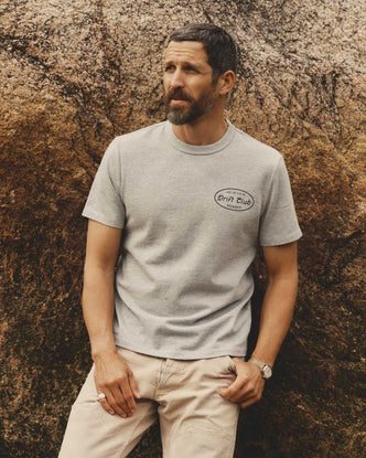 fit model leaning against the wall wearing The Organic Cotton Shop Tee in Drift Club