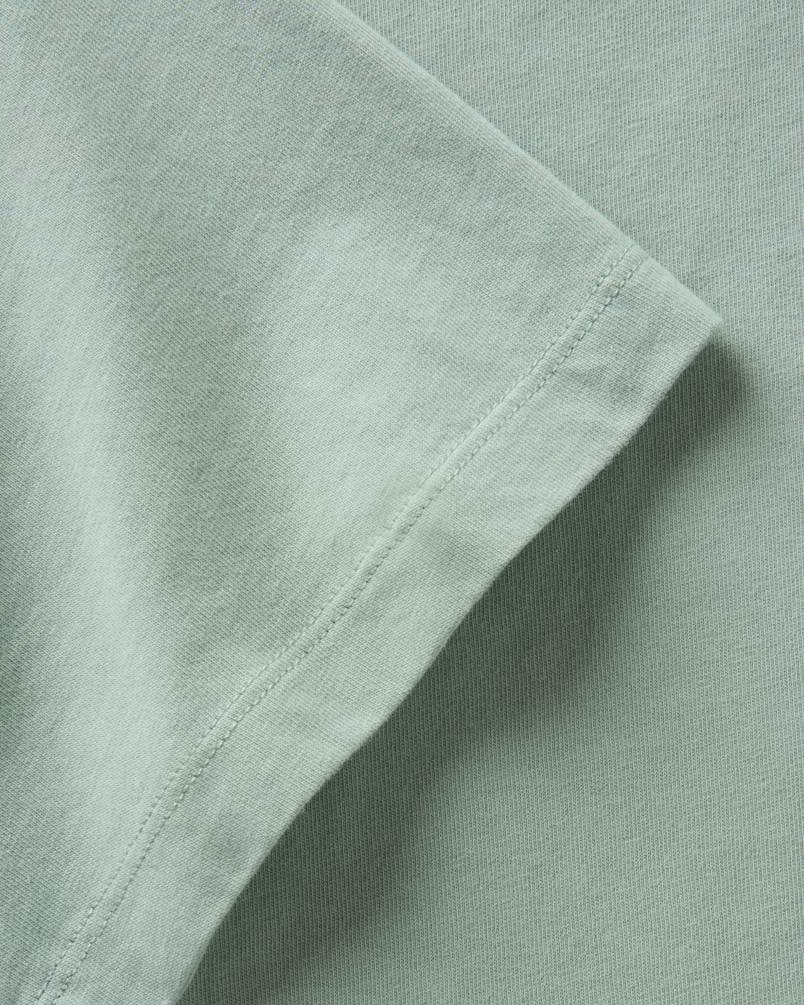 material shot of the sleeve on The Regenerative Cotton Tee in Faded Pine, Knits by Taylor Stitch
