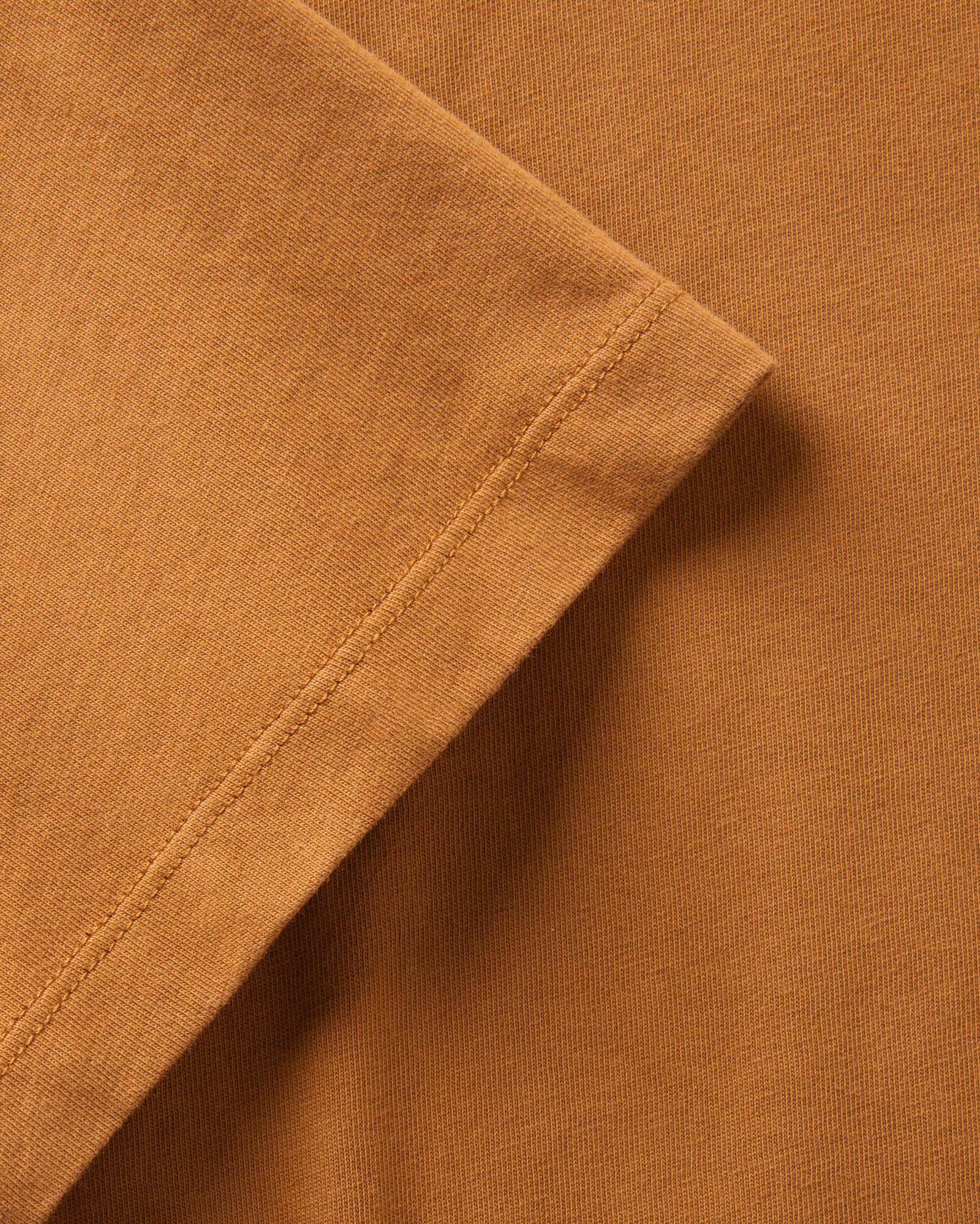 material shot of the sleeve on The Regenerative Cotton Tee in Saffron, Knits by Taylor Stitch