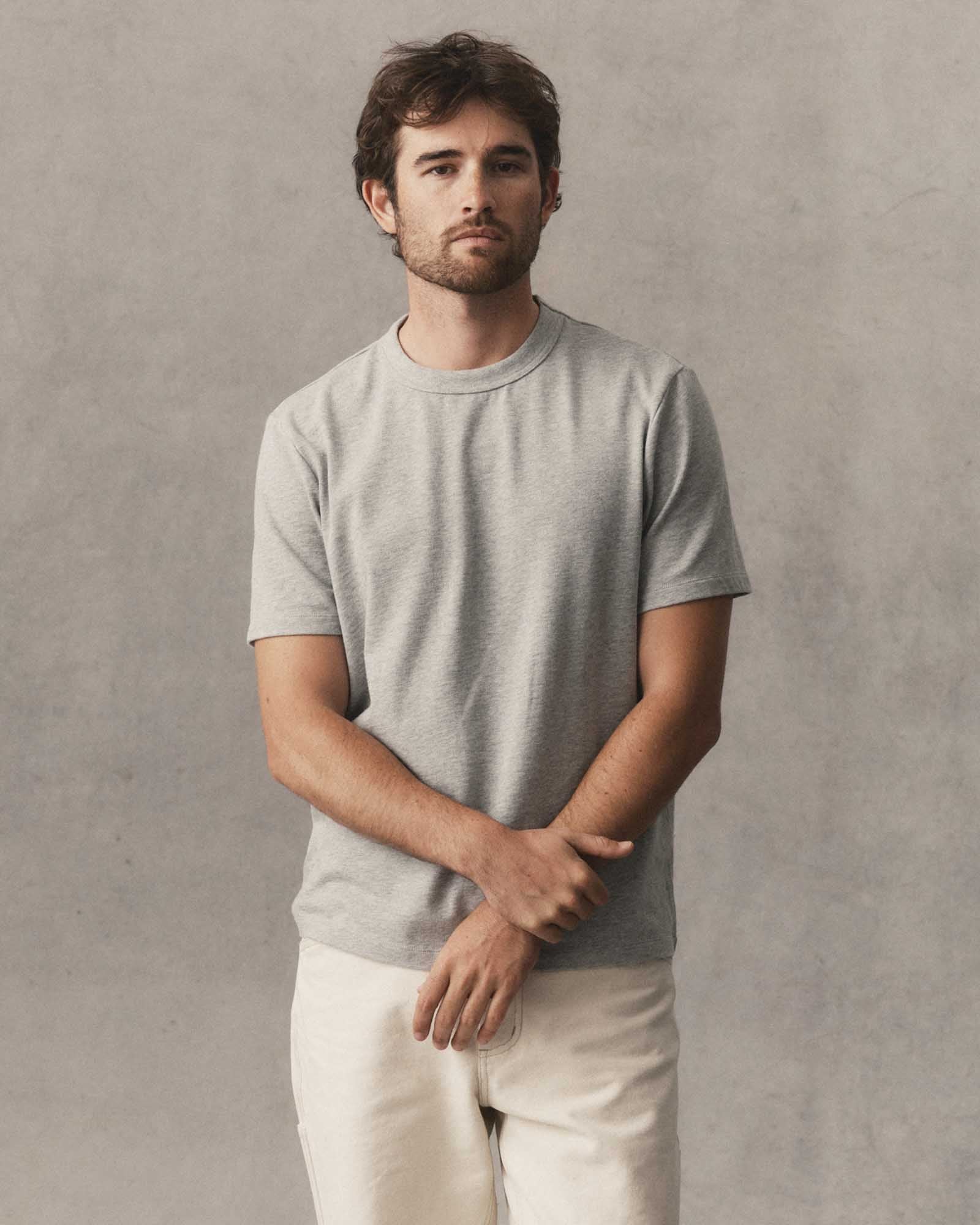 fit model posing in The Organic Cotton Shop Tee in Heather Grey, Knits by Taylor Stitch