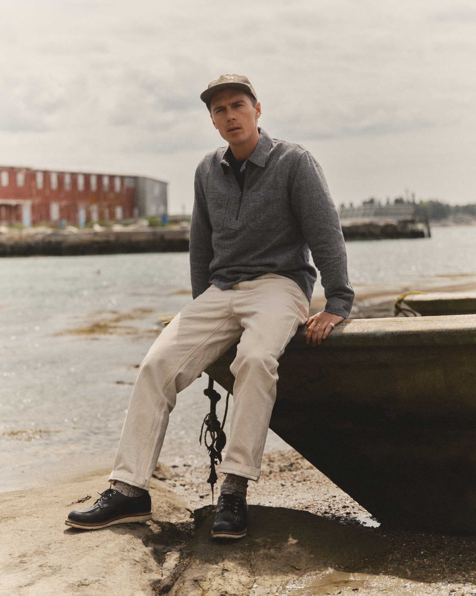fit model sitting wearing The Tiller Half Zip in Greyscale Hemp Jaspe, Wovens by Taylor Stitch