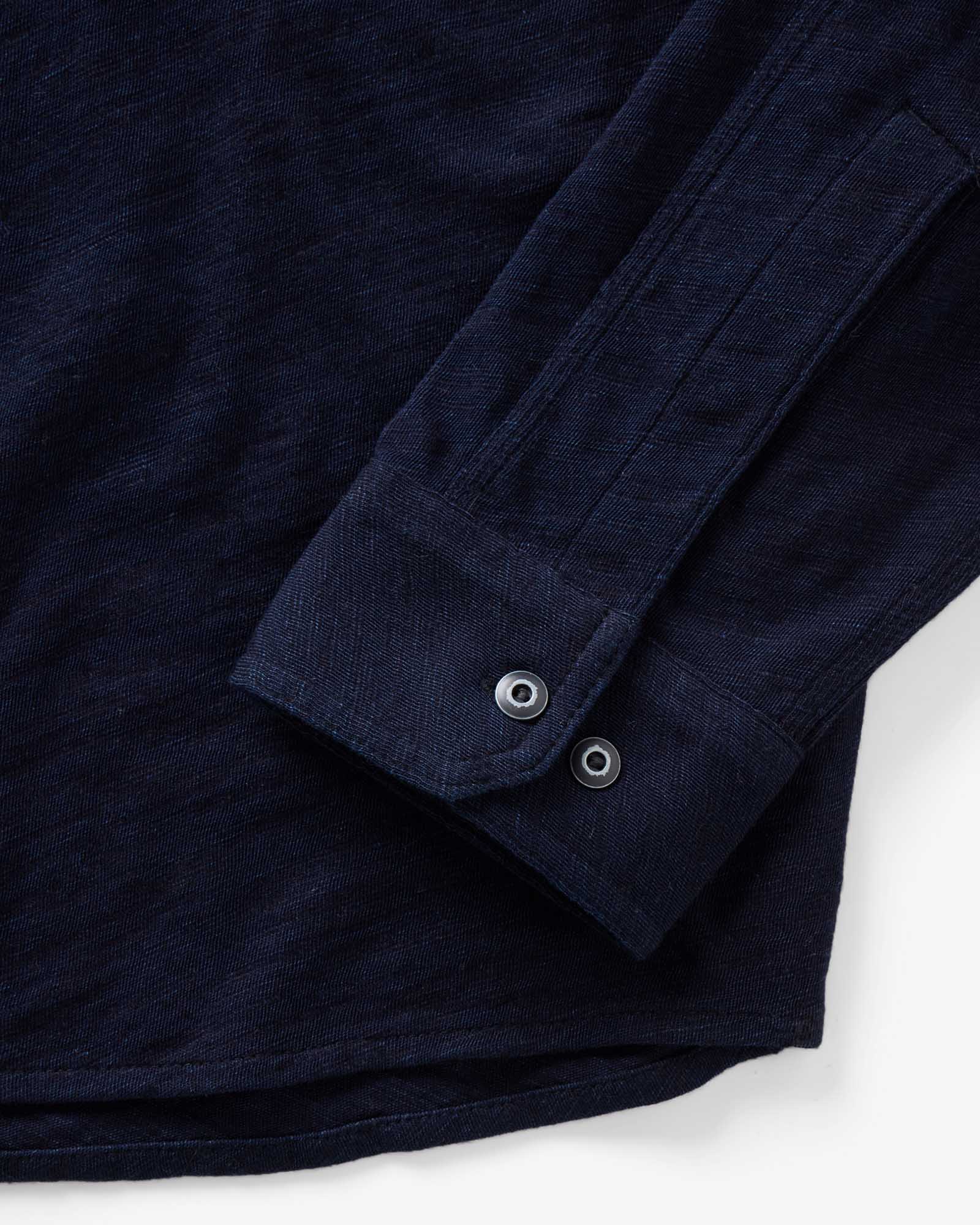 material shot of the sleeve on The Tiller Half Zip in Rinsed Indigo Slub, Knits by Taylor Stitch
