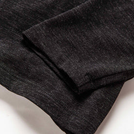 material shot of the sleeves on The Merino Henley in Heather Black