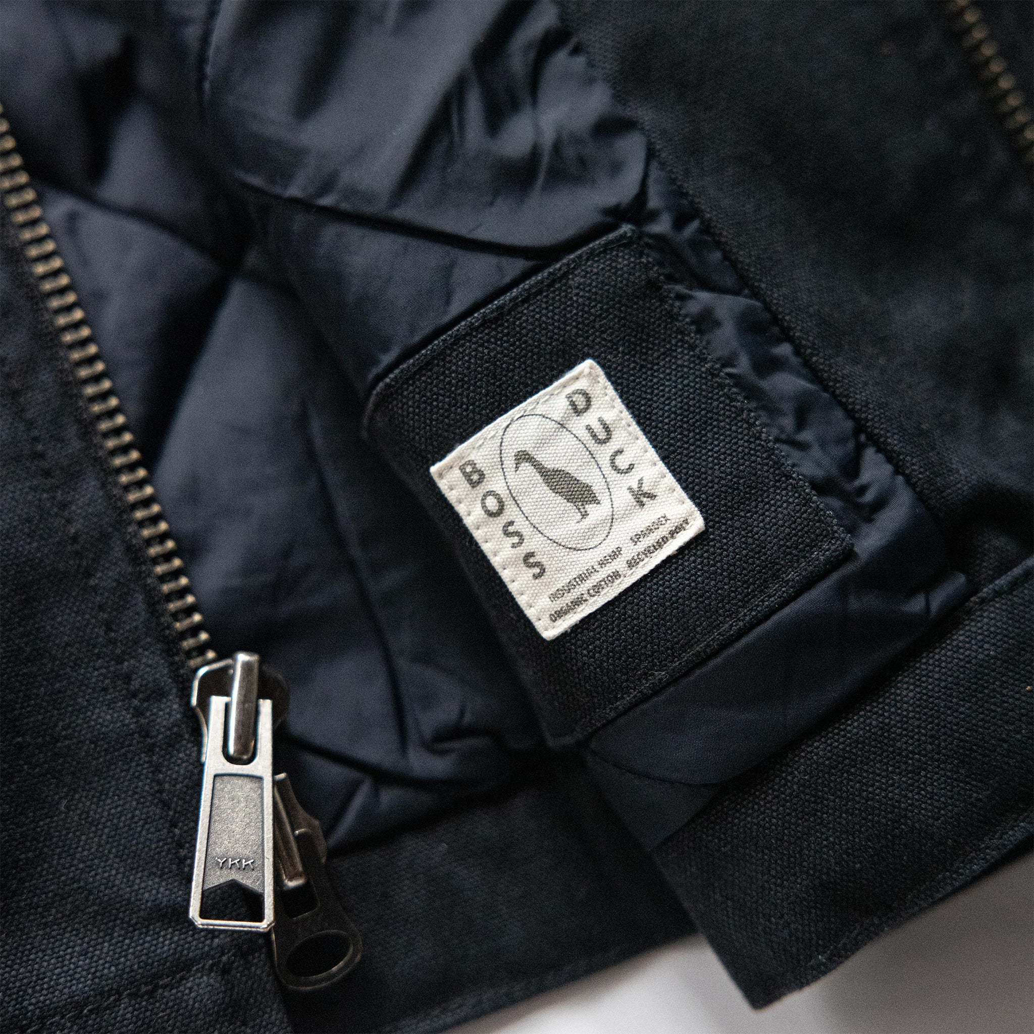 material shot of the YKK zipper on The Workhorse Vest in Coal Boss Duck, Outerwear by Taylor Stitch