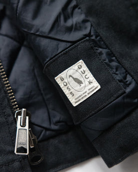material shot of the YKK zipper on The Workhorse Vest in Coal Boss Duck, Outerwear by Taylor Stitch