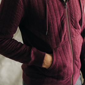 fit model with his hand in the pocket of The Apres Zip Hoodie in Burgundy Quilt