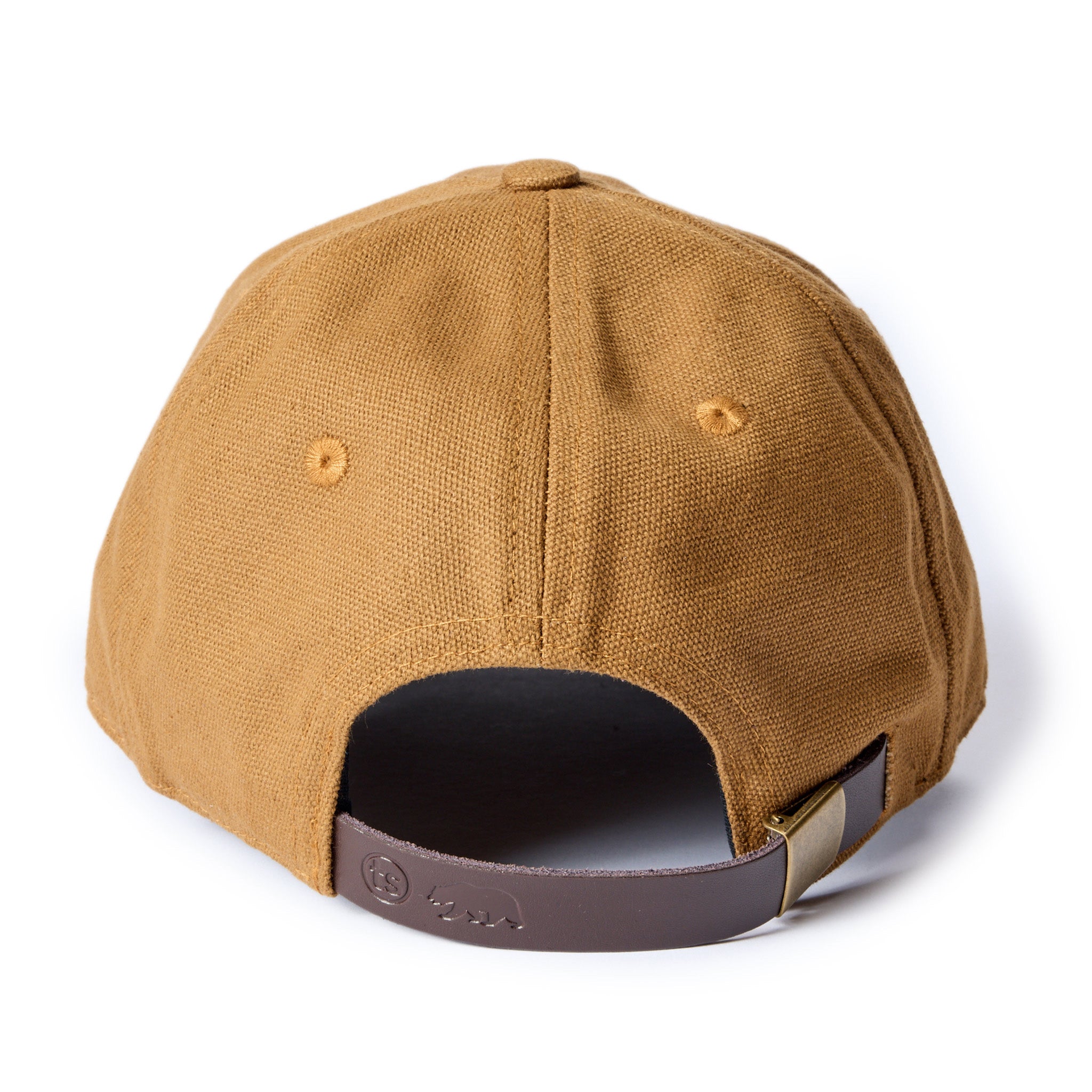 flatlay of The Ball Cap in Tobacco Canvas, showing the leather slide adjustment, Accessories by Taylor Stitch