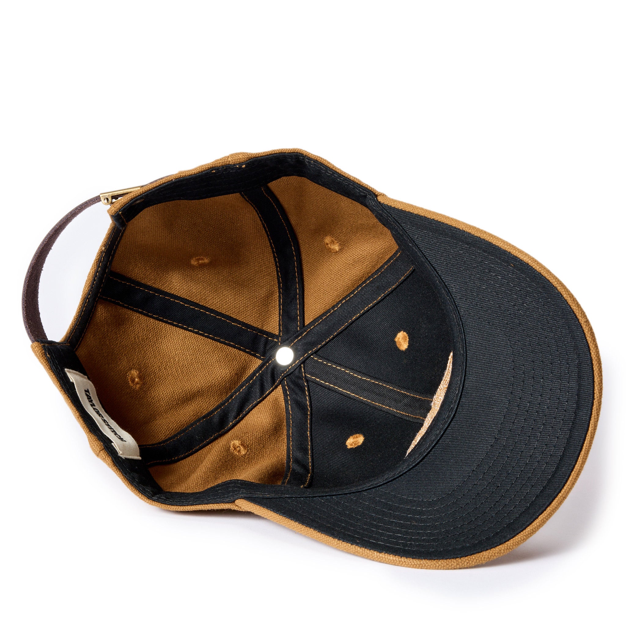flatlay of The Ball Cap in Tobacco Canvas, showing the underside, Accessories by Taylor Stitch