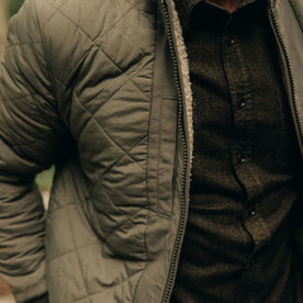 fit model showing the quilted side of The Carson Jacket in Light Khaki Fleece
