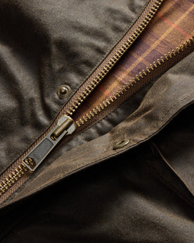 material shot of the YKK zipper on The Clutch Jacket in Soil Waxed Canvas, Outerwear by Taylor Stitch