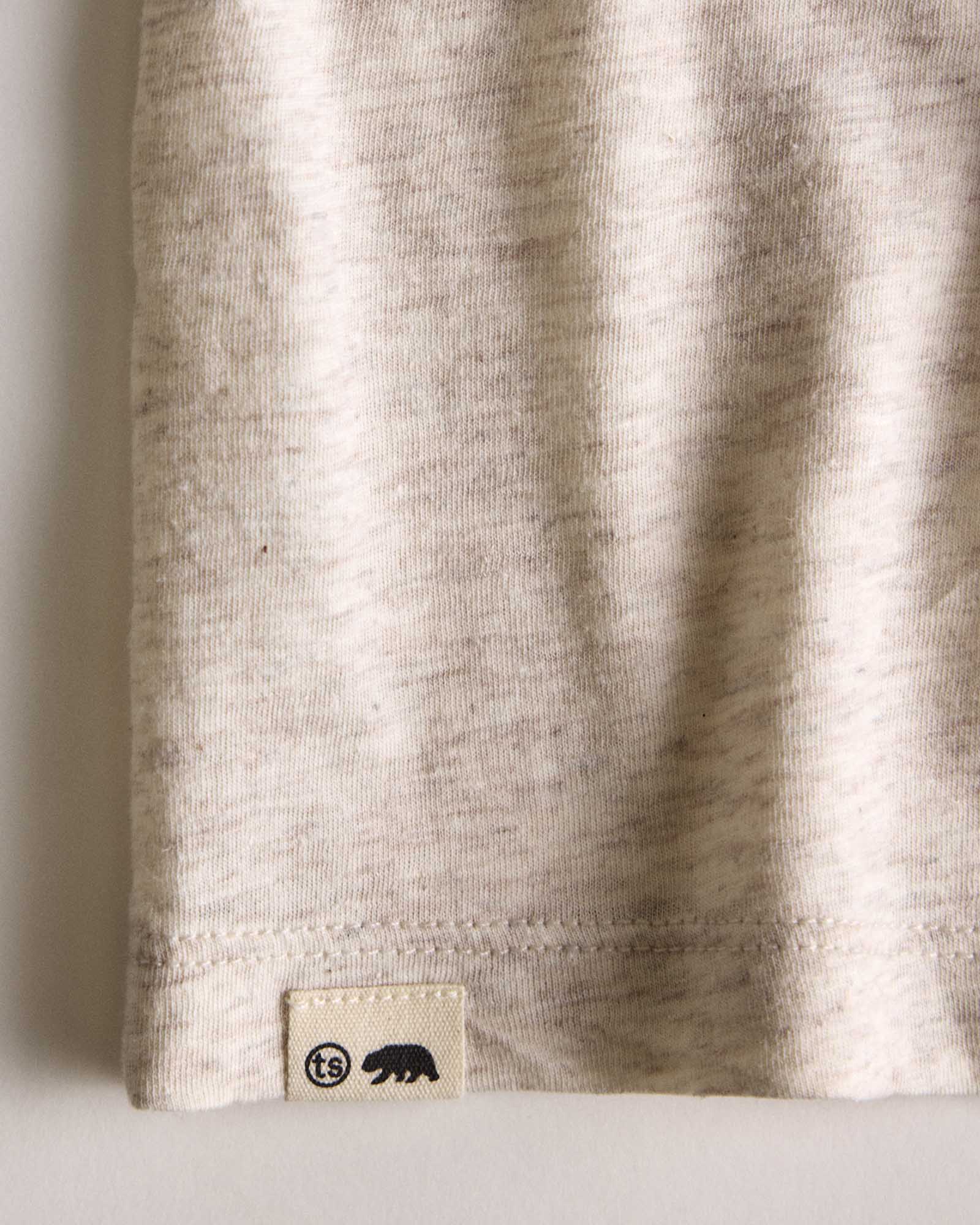 fit model showing the hem on The Cotton Hemp Long Sleeve Tee in Heathered Oat, Knits by Taylor Stitch