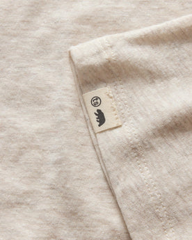 material shot of the logo tag on The Cotton Hemp Tee in Heather Oat, Knits by Taylor Stitch
