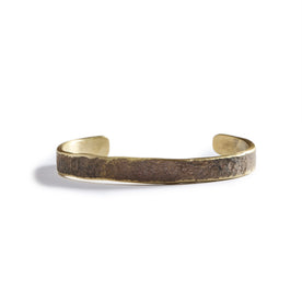 flatlay of The Hammered Cuff in Brass
