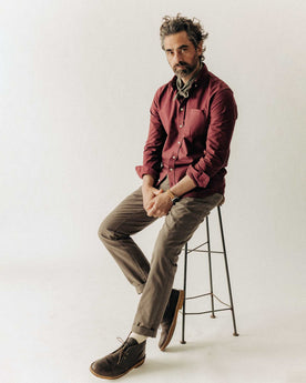 fit model sitting wearing The Jack in Burgundy Oxford, Wovens by Taylor Stitch
