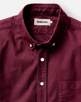 fit model adjusting his sleeves in The Jack in Burgundy Oxford, Wovens by Taylor Stitch