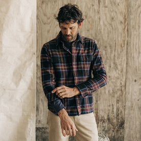 fit model adjusting his sleeves in The Ledge Shirt in Dark Navy Plaid