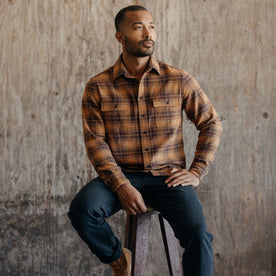 fit model sitting in The Ledge Shirt in Tarnished Brass Plaid