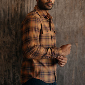 fit model buttoning the cuffs on The Ledge Shirt in Tarnished Brass Plaid