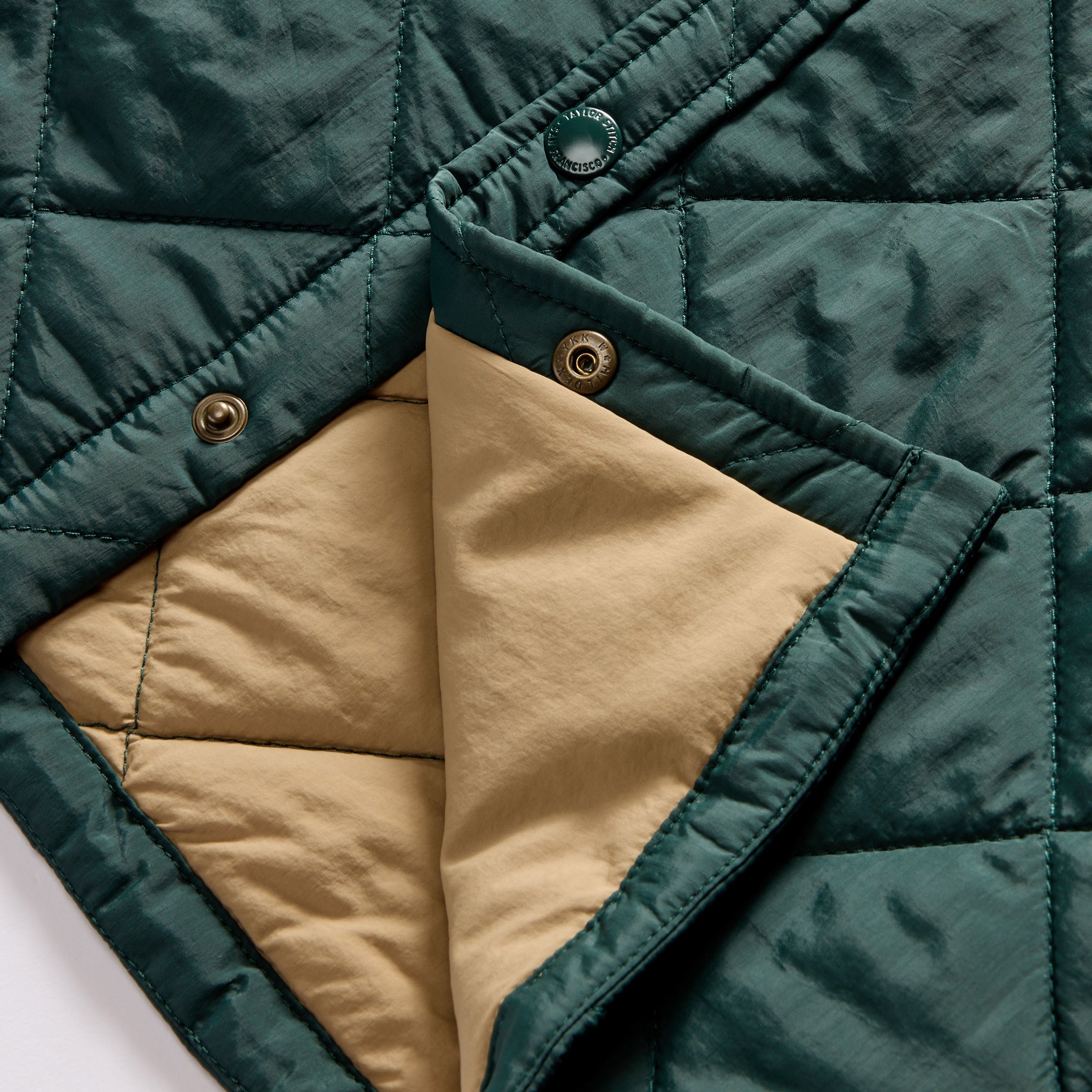 material shot of the snap buttons and quilted lining on The Miller Shirt Jacket in Conifer, Outerwear by Taylor Stitch