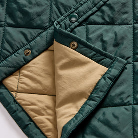 material shot of the snap buttons and quilted lining on The Miller Shirt Jacket in Conifer