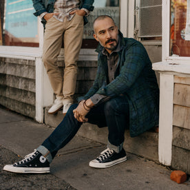fit model sitting on a stoop in The Ojai Jacket in Blackwatch Plaid Diamond Quilt