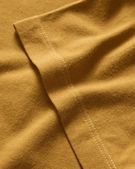 material shot of the sleeves on The Organic Cotton Tee in Old Gold, Knits by Taylor Stitch