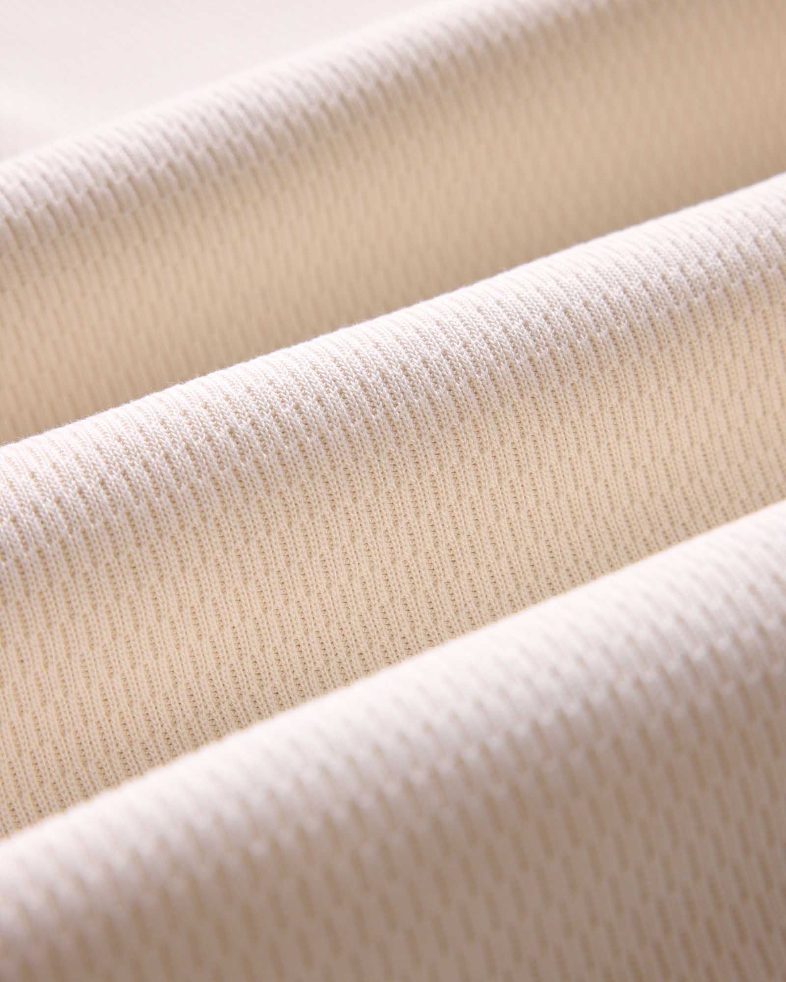 material shot of the ribbed cuffs on The Organic Cotton Waffle Crew in Natural, Knits by Taylor Stitch