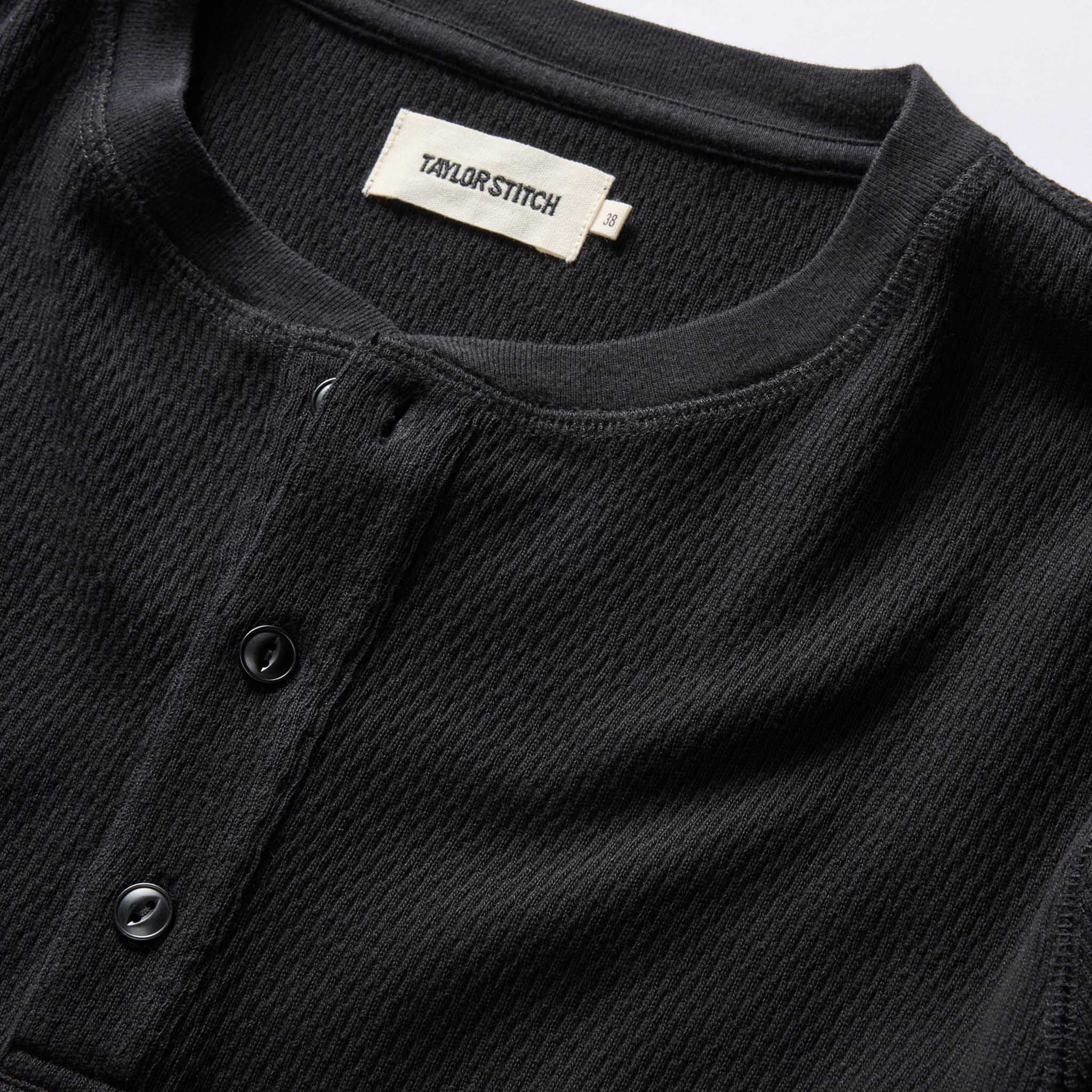 material shot of the neck opening and front placket on The Organic Cotton Waffle Henley in Coal, Knits by Taylor Stitch
