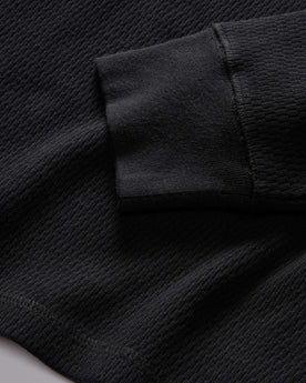 material shot of the rubbed cuff on The Organic Cotton Waffle Henley in Coal, Knits by Taylor Stitch
