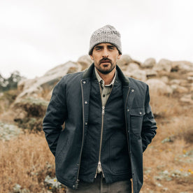 fit model standing in The Orr Beanie in Marled Coal