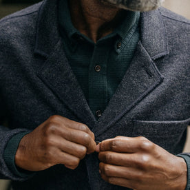 fit model buttoning The Ridgewood Cardigan in Navy Birdseye Wool