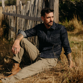 fit model sitting in The Saddler Shirt in Dark Navy Twill