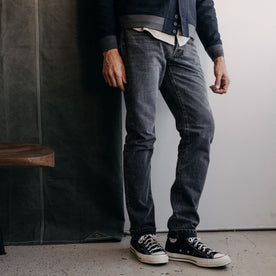 fit model standing in The Slim Jean in Black 1-Year Wash Selvage Denim