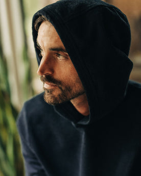 fit model with the hood up in The Apres Hoodie in Indigo Terry, Knits by Taylor Stitch